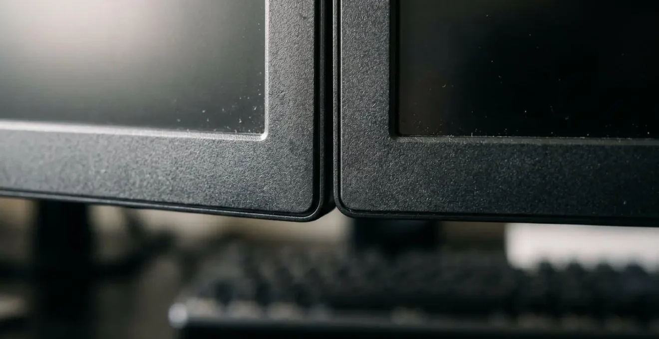 Optimal dual monitor arrangement showing proper height alignment and viewing angles for developers to prevent neck strain and maintain deep work capacity